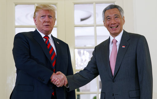 President Donald Trump shakes hands as he meets with Singapore Prime Minister Lee Hsien Loong ahead of a summit with North Korean leader Kim Jong Un, Monday, June 11, 2018, in Singapore. [Photo: AP]
