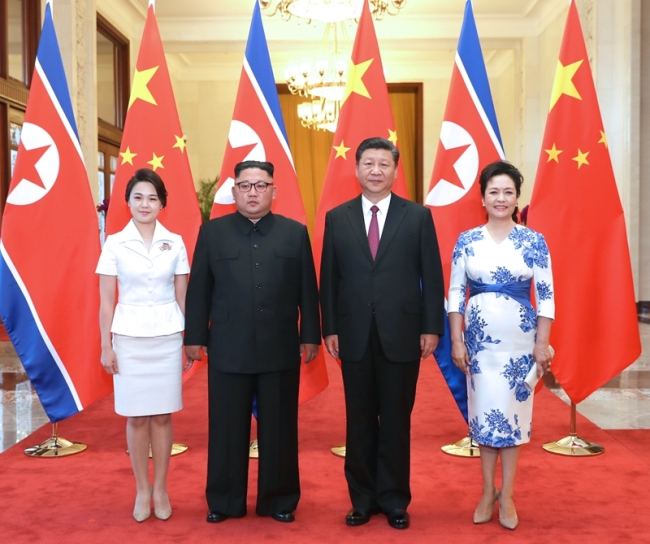 Xi Jinping (2nd R), general secretary of the Central Committee of the Communist Party of China and Chinese president, and his wife Peng Liyuan (1st R) meet with Kim Jong Un (2nd L), chairman of the Workers' Party of Korea and chairman of the State Affairs Commission of the Democratic People's Republic of Korea (DPRK), and his wife Ri Sol Ju in Beijing on Tuesday, June 19, 2018. [Photo: Xinhua]