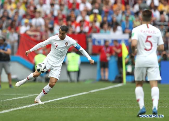 Cristiano Ronaldo (L) of Portugal controls the ball during a Group B match between Portugal and Morocco at the 2018 FIFA World Cup in Moscow, Russia, June 20, 2018. 
