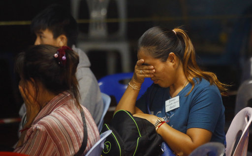 Family members react after hearing the news that the missing 12 boys and their soccer coach have been found, in Mae Sai, Chiang Rai province, in northern Thailand, Monday, July 2, 2018. A Thai provincial governor says all 12 boys and their coach have been found alive in the cave where they went missing over a week ago in northern Thailand. [Photo: AP]