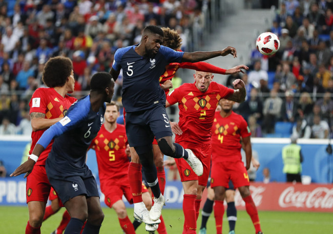 France's Samuel Umtiti, (5) heads the ball to score the opening goal of the game during the semifinal match between France and Belgium at the 2018 soccer World Cup in the St. Petersburg Stadium in, St. Petersburg, Russia, Tuesday, July 10, 2018. [Photo: AP/Natacha Pisarenko]