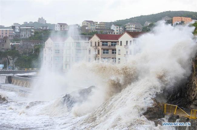 Huge waves beat against the sea shore in Shitang Township of Wenling City, east China's Zhejiang Province, July 10, 2018, as Typhoon Maria, the eighth typhoon this year, approaches the coast. 