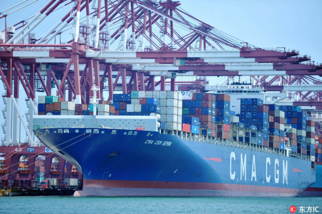 A cargo ship of CMA CGM Group loaded with containers to be shipped abroad berths on a quay at the Port of Qingdao in Qingdao city, east China's Shandong province, 6 July 2018.[Photo: IC]