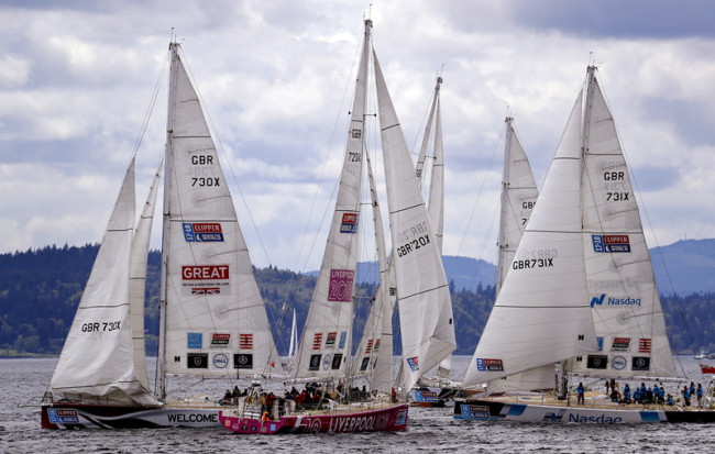 Sailboats in the Clipper Round the World Yacht Race crowd together as they make a turn during a two-lap, short course race in Elliott Bay, Sunday, April 29, 2018, in Seattle. [Photo: AP/Elaine Thompson]
