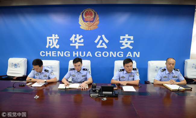 On Tuesday, August 14, 2018 local police officers speak about the case from the weekend where a boy was bitten by a German Shepherd in Chengdu, Sichuan Province. [Photo: Chengdu Business Daily/VCG]