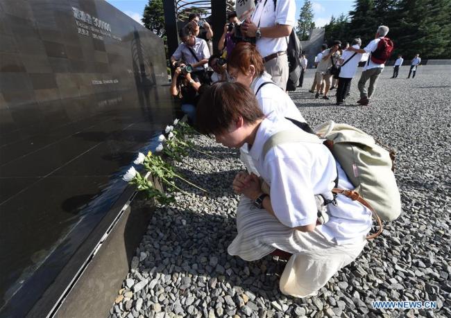 Members of a visiting Japanese delegation lay flowers at The Memorial Hall of the Victims in Nanjing Massacre by Japanese Invaders in east China's Jiangsu Province, Aug. 15, 2018. 