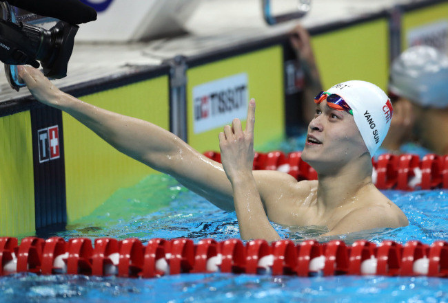 Sun Yang of China celebrates after winning the gold medal at men's 200m freestyle final at the GBK Aquatics Center in Jakarta, Indonesia on Aug 19, 2018. [Photo: Xinhua]