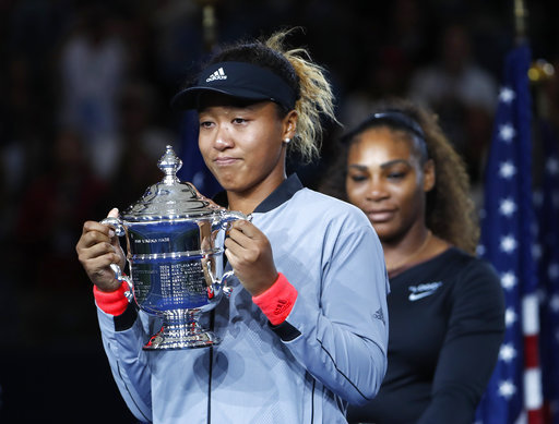 Naomi Osaka, of Japan, holds the trophy after defeating Serena Williams in the women's final of the U.S. Open tennis tournament, Saturday, Sept. 8, 2018, in New York. [Photo: AP/Adam Hunger]