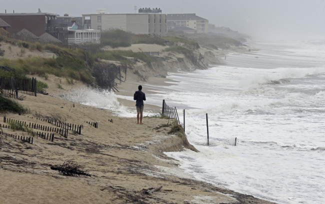 Heavy surf crashes the dunes at high tide in Nags Head, N.C., Thursday, Sept. 13, 2018 as Hurricane Florence approaches the east coast. [File photo: AP/Gerry Broome]