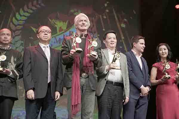 Laurence Brahm (third from left) took home two awards of the documentary category for Searching for the Lotus-Born Master at Canada Golden Maple Film Festival. [Photo: China Daily]