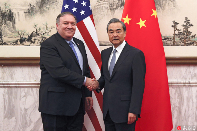 U.S. Secretary of State Mike Pompeo, left, shakes hands with Chinese Foreign Minister Wang Yi before their meeting at the Diaoyutai State Guesthouse in Beijing, Monday, Oct. 8, 2018. [Photo: IC]