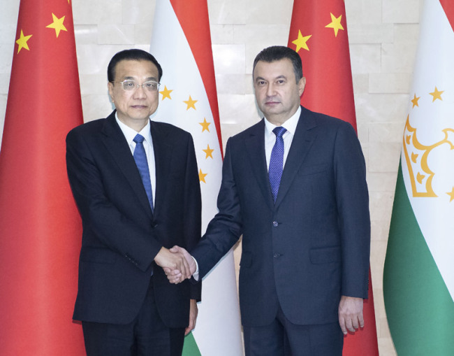 Chinese Premier Li Keqiang shakes hands with Tajik Prime Minister Kokhir Rasulzoda in Dushanbe, the capital of Tajikistan, on Saturday, October 13, 2018. [Photo: gov.cn]