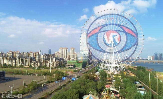 The image of a giant eye containing an icon for Virtual Reality technology has been painted on the world's third-tallest Ferris wheel, the Nanchang Star, seen here on Tuesday, October 16, 2018, ahead of the World VR industry conference to be held on Friday in Nanchang, Jiangxi Province.[Photo:VCG]