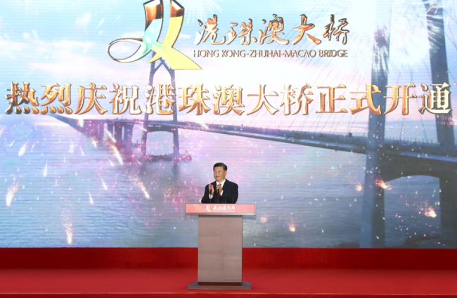 Chinese President Xi Jinping, also general secretary of the Communist Party of China Central Committee and chairman of the Central Military Commission, announces the opening of the Hong Kong-Zhuhai-Macao Bridge at an opening ceremony in Zhuhai, south China's Guangdong Province, Oct. 23, 2018. [Photo: Xinhua/Xie Huanchi]