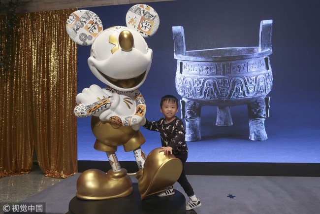 The launch ceremony for cultural and creative products based on Mickey Mouse and a 3,000-year-old bronze food vessel is held at the Shanghai Museum on October 29, 2018. [Photo: VCG]
