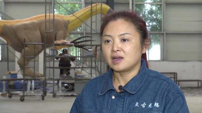 Gan Jufang, factory head at Gengu Dinosaurs calls her workplace “home.”[Photo: CGTN]