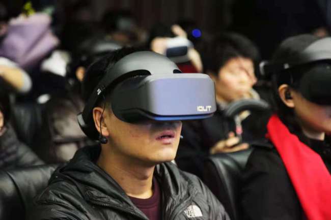 An audience wearing virtual reality glasses watches the Australian-Chinese feature film "The Calling" in Beijing on Friday, November 2, 2018.[Photo provided to China Plus]