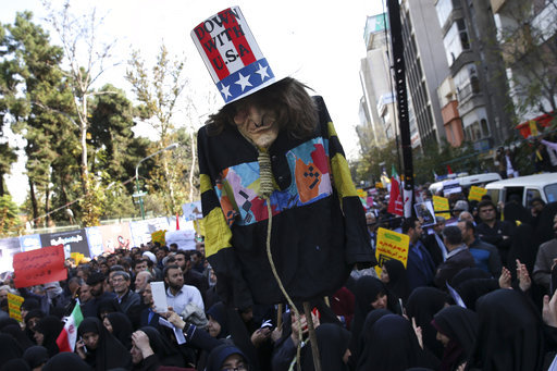 An effigy of U.S. government icon "Uncle Sam" is held up by demonstrators during a rally in front of the former U.S. Embassy in Tehran, Iran, on Sunday, Nov. 4, 2018, marking the 39th anniversary of the seizure of the embassy by militant Iranian students. Thousands of Iranians rallied in Tehran on Sunday to mark the anniversary as Washington restored all sanctions lifted under the nuclear deal. [Photo: AP]