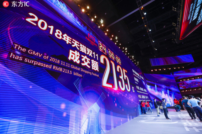A giant electronic screen shows the total GMV (Gross Merchandise Volume) from online shopping on Chinese e-commerce giant Alibaba's marketplaces Tmall and Taobao on November 11 reaching RMB 213.5 billion yuan ($30.8 billion U.S. dollars) during the Tmall 11.11 Global Shopping Festival 2018 at the media center in Shanghai, China, 12 November 2018.[IC]