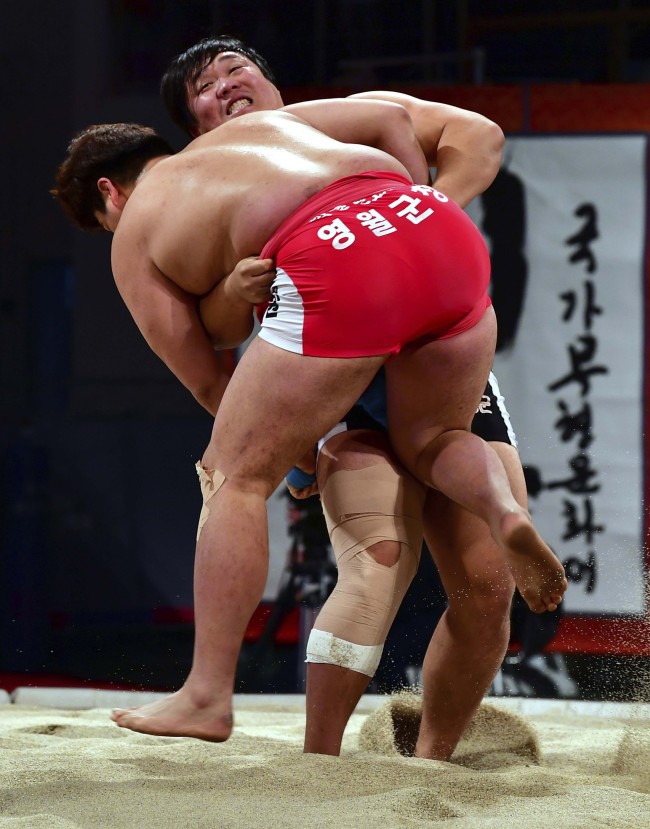 In this Nov. 26, 2017 photo, ssireum wrestlers compete during the Korea Open Ssireum Festival in Naju, South Korea.