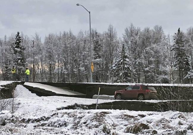 A car is trapped on a collapsed section of the offramp off of Minnesota Drive in Anchorage, Friday, Nov. 30, 2018. [Photo: AP]