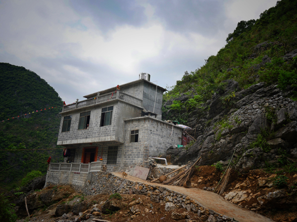 A residential house is almost completed along the main road in Baohao Village, south China's Guangxi Zhuang Autonomous Region. [Photo: China Plus/Wang Xin] 