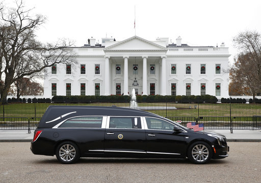 The hearse carrying the flag-draped casket of former President George H.W. Bush passes by the White House from the Capitol, heading to a State Funeral at the National Cathedral, Wednesday, Dec. 5, 2018, in Washington. [Photo: AP]