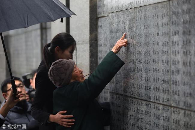 Xia Shuqin, a survivor of the Nanjing Massacre, pays tribute to her relatives who died in the tragedy on December 10, 2018 at the Memorial Hall of the Victims in Nanjing Massacre. [Photo: VCG]