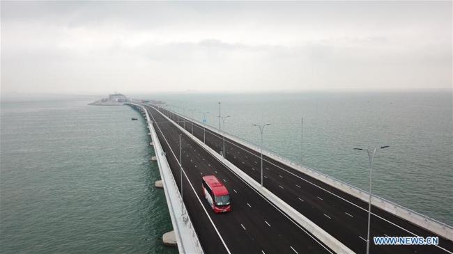 Aerial photo taken on Oct. 24, 2018 shows a car running on the Hong Kong-Zhuhai-Macao Bridge. The Hong Kong-Zhuhai-Macao bridge, the world's longest cross-sea bridge, opened to public traffic Wednesday. [Photo: Xinhua/Lui Siu Wai]