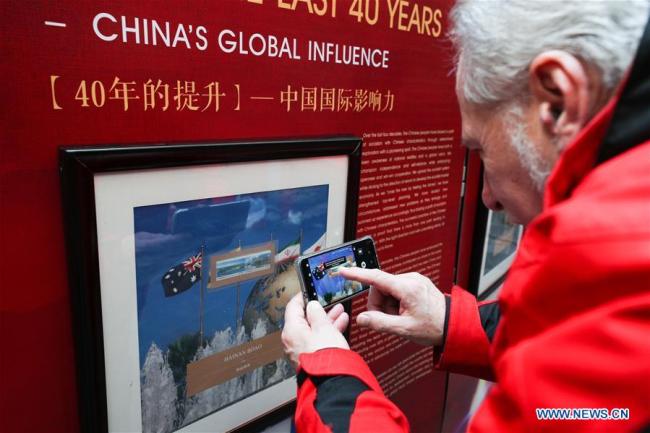 A visitor takes photos of the stamps showing China's global influence during the "China-Great Change" stamp exhibition in Leuven, Belgium, Dec. 11, 2018. A large-scale stamp exhibition was opened Tuesday at Belgium's University of Leuven to commemorate the 40th anniversary of China's reform and opening up. Themed "China - Great Change", the exhibition, showcasing 188 stamps, aims to offer a glimpse into the significant changes that have transpired in China over the last four decades.[Photo:Xinhua]