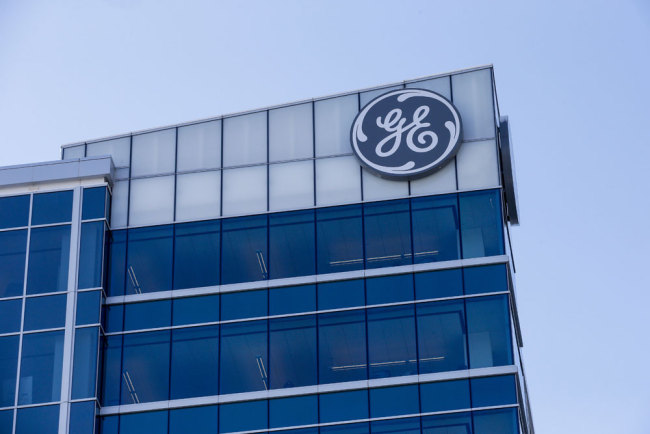  In this Jan. 16, 2018, photo, the General Electric logo is displayed at the top of their Global Operations Center in the Banks development of downtown Cincinnati. General Electric Co. reports earnings Friday, July 20.[Photo:AP]