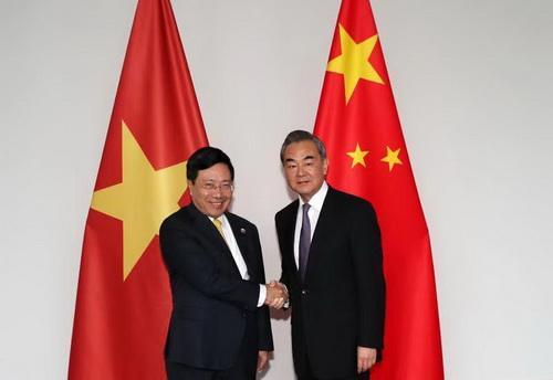 Chinese State Councilor and Foreign Minister Wang Yi (R) shakes hands with Vietnamese Deputy Prime Minister and Minister for Foreign Affairs Pham Binh Minh in Luang Prabang, Laos on December 16, 2018. [Photo: fmprc.gov.cn]