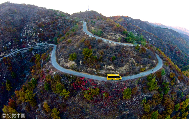 A school bus on a mountain road in Huachangyu village, Hebei Province, October 18 2018. [Photo: VCG]