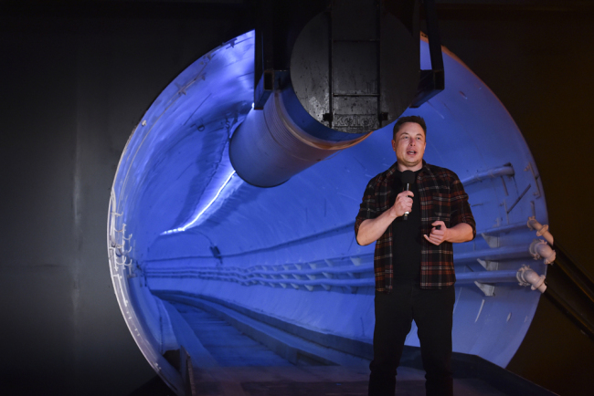 Elon Musk, co-founder and chief executive officer of Tesla Inc., speaks during an unveiling event for the Boring Co. Hawthorne test tunnel in Hawthorne, Calif., on Tuesday, Dec. 18, 2018. [Photo: Pool via AP Robyn Beck]