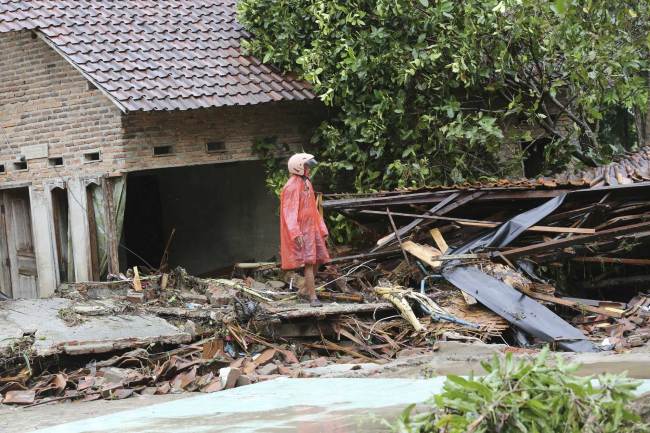 A resident inspects his house damaged by a tsunami, in Sumur village, Indonesia, Monday, Dec. 24, 2018. [Photo: AP/Tatan Syuflana]