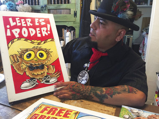 In this Thursday, April 5, 2018 photo artist Moises Salcedo of Albuquerque, who goes by the name El Moises, shows a panel of characters for the bilingual children's book "Owl in a Straw Hat" at his home and studio in Albuquerque, N.M. on Thursday, April 5, 2018. He and celebrated Chicano author Rudolfo Anaya crafted the book that follows the adventure in English and Spanish of a tiny owl named Oli who longs to read on his own, even as he skips school and tangles with a cast of conniving animal characters in the hills and skies of northern New Mexico. A sequel is planned to address concerns about bullying. [Photo: AP]