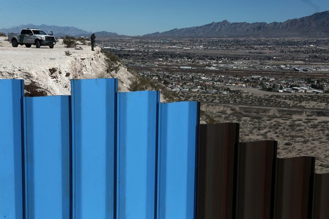 In this Jan. 25, 2017, file photo, an agent from the border patrol, observes near the Mexico-US border fence, on the Mexican side, separating the towns of Anapra, Mexico and Sunland Park, N.M. An 8-year-old boy from Guatemala died in government custody early Tuesday, Dec. 25, 2018, U.S. immigration authorities said. [File photo: AP /Christian Torres]