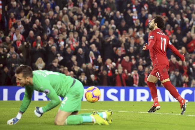 Liverpool's Mohamed Salah, right, celebrates after scoring on a penalty kick his side's second goal during the English Premier League soccer match between Liverpool and Newcastle at Anfield Stadium, Liverpool, England, Wednesday, Dec. 26, 2018. [Photo: AP]