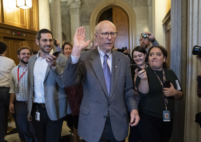 With reporters seeking comment, Republican Senator Pat Roberts of Kansas, chairman of the Senate Agriculture Committee, departs after he opened and closed a brief session of the U.S. Senate amid the partial government shutdown, at the Capitol in Washington, Thursday, Dec. 27, 2018. [Photo: AP/J. Scott Applewhite]