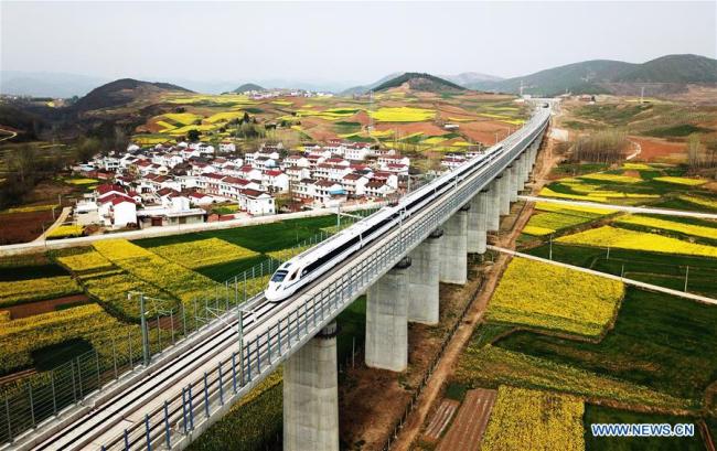 A bullet train runs on the Yangxian section of Xi'an-Chengdu high-speed railway line in northwest China's Shaanxi Province, March 21, 2018. China has pledged to coordinate its efforts of environmental protection and economic development in 2019, an important year for winning the tough battle against pollution. [Photo: Xinhua]