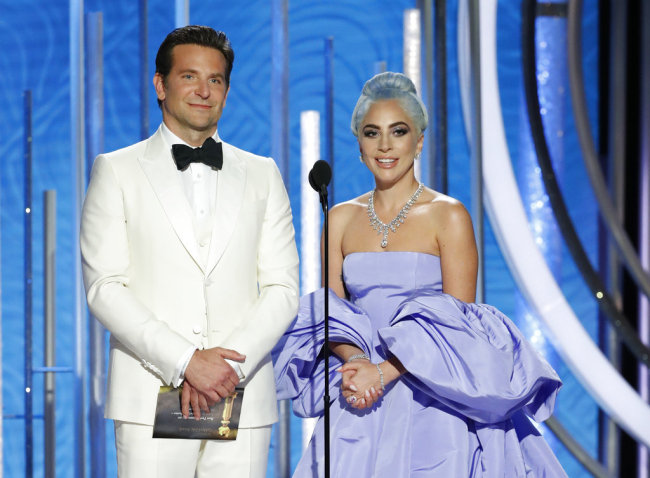This image released by NBC shows Bradley Cooper, left, and Lady Gaga presenting the award for best actor in a TV comedy series at the 76th Annual Golden Globe Awards at the Beverly Hilton Hotel on Sunday, Jan. 6, 2019, in Beverly Hills, Calif. [Photo: NBC via AP/Paul Drinkwater]
