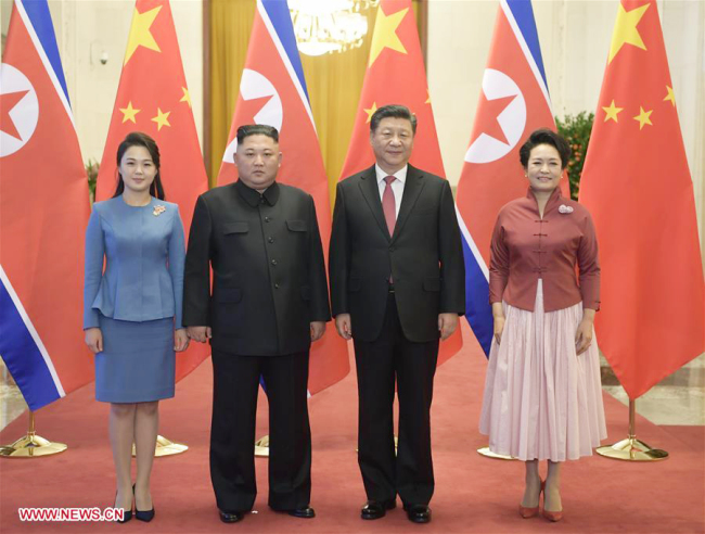 Xi Jinping (2nd R), general secretary of the Central Committee of the Communist Party of China and Chinese president, and his wife Peng Liyuan (1st R) pose for photos with Kim Jong Un (2nd L), chairman of the Workers' Party of Korea and chairman of the State Affairs Commission of the Democratic People's Republic of Korea, and his wife Ri Sol Ju in Beijing, capital of China, Jan. 8, 2019. Xi Jinping on Tuesday held talks with Kim Jong Un, who arrived in Beijing on the same day for a visit to China. Before the talks, Xi Jinping held a welcoming ceremony for Kim Jong Un at the Great Hall of the People in Beijing. [Photo: Xinhua]