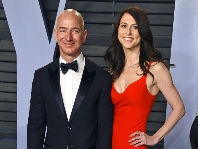 In this March 4, 2018 file photo, Jeff Bezos and wife MacKenzie Bezos arrive at the Vanity Fair Oscar Party in Beverly Hills, Calif. Bezos says he and his wife, MacKenzie, have decided to divorce after 25 years of marriage. Bezos, one of the world's richest men, made the announcement on Twitter Wednesday, Jan. 9, 2019. [File photo: Invision/AP/Evan Agostini]