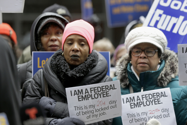 Government workers rally against the partial government shutdown at Federal Plaza, Thursday, Jan. 10, 2019, in Chicago. The partial government shutdown continues to drag on with hundreds of thousands of federal workers off the job or working without pay as the border wall fight persists. [Photo: AP/Kiichiro Sato]