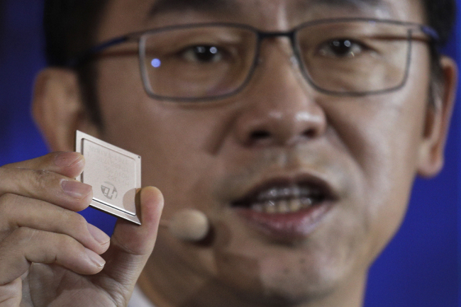 Ryan Ding, chief of Huawei's carrier business group, holds a Tiangang 5G base station chipset, speaks during a product presentation in Beijing, Thursday, Jan. 24, 2019. [Photo: AP: Andy Wong]