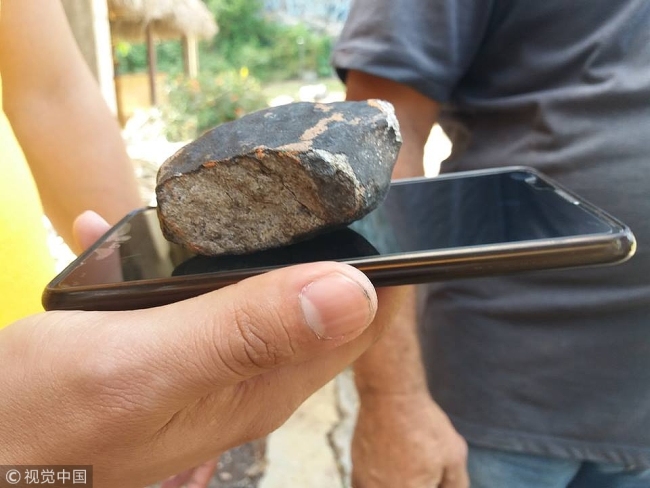 Handout picture released by Tele Pinar, a local television station, showing an alleged piece of a meteorite that fell in Cuba on February 1, 2019, taken in Vinales, in the Cuban western province of Pinar del Rio. [Photo: VCG]