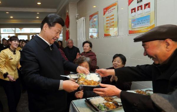 Chinese president Xi Jinping gives food to aged people at a restaurant in Lanzhou, Gansu Province. [Photo: Xinhua]