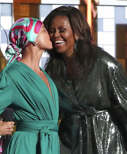 Alicia Keys, left, kisses Michelle Obama at the 61st annual Grammy Awards on Sunday, Feb. 10, 2019, in Los Angeles. [Photo:AP/Matt Sayles/Invision]