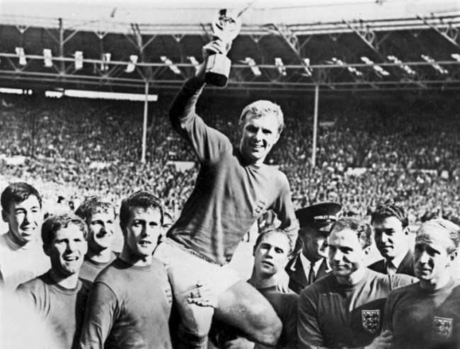 In this file photo taken on July 30, 1966 England's national soccer team captain Bobby Moore (C) holds aloft the Jules Rimet World Cup trophy as he is carried by his teammates including (from L) Gordon Banks, Alan Ball, Roger Hunt, Geoff Hurst, Ray Wilson, George Cohen and Bobby Charlton, following England's victory over Germany (4-2 in extra time) in the World Cup final 30 July 1966 at Wembley stadium in London. [Photo: AFP]