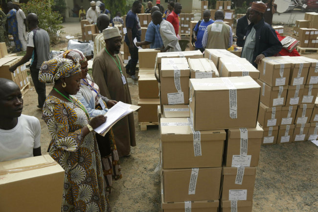 An electoral worker takes stock of ballot papers to be transporters at the offices of the Independent National Electoral Commission in Yola, Nigeria, Feb. 15, 2019. [Photo: AP/Sunday Alamba]